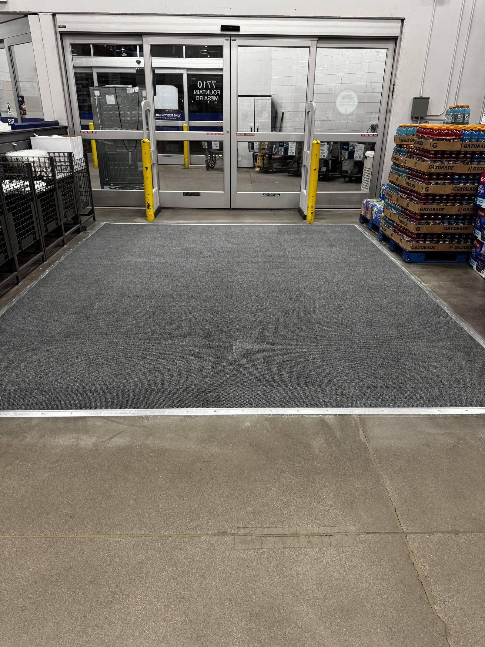 New walk-off carpet installed at a retail store entrance