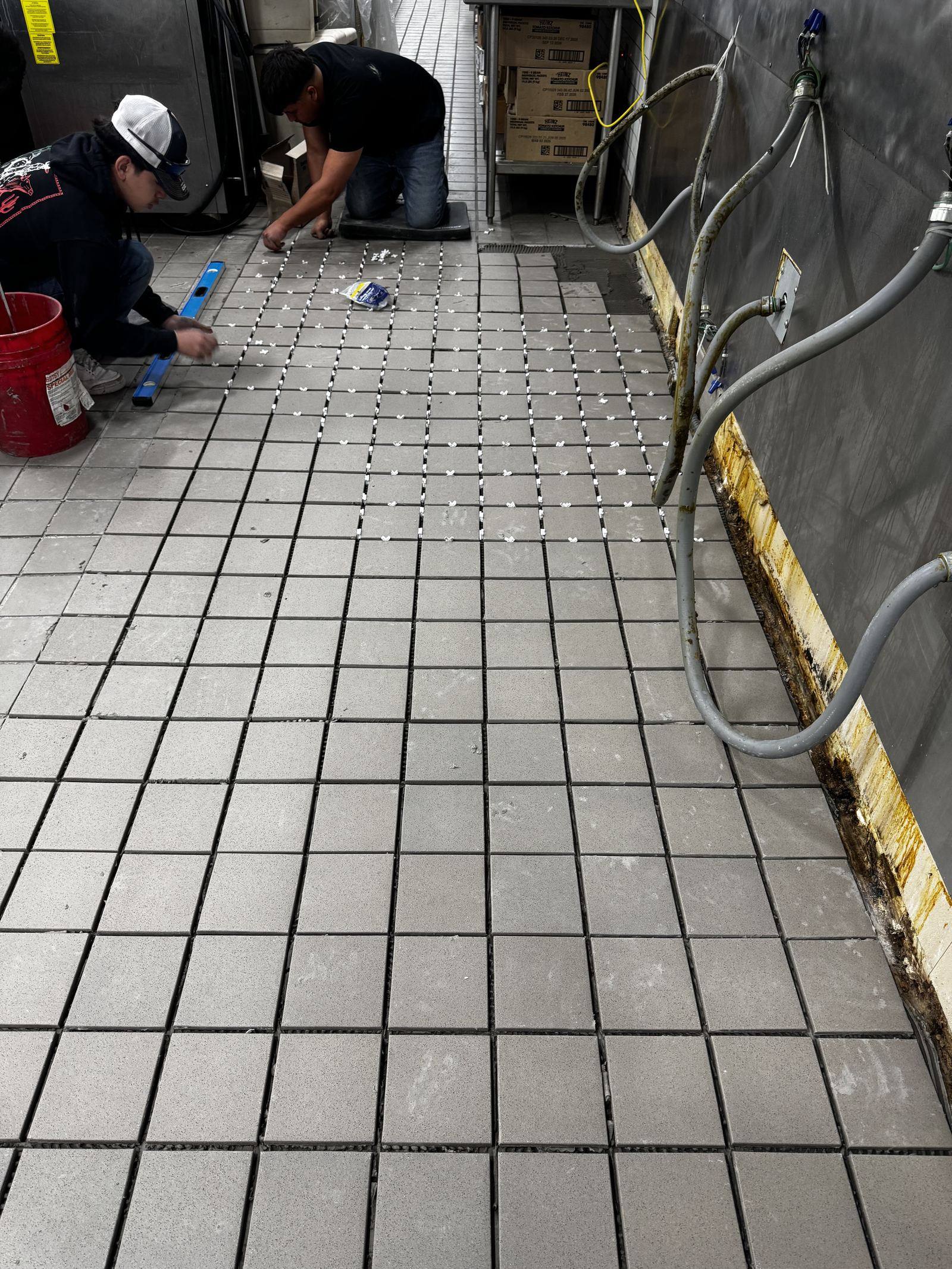 Crew laying commercial floor tile